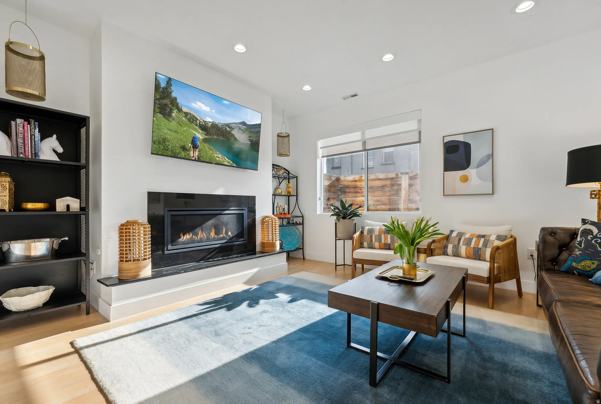 Living space featuring a built-in linear fireplace with a dark stone surround and hearth