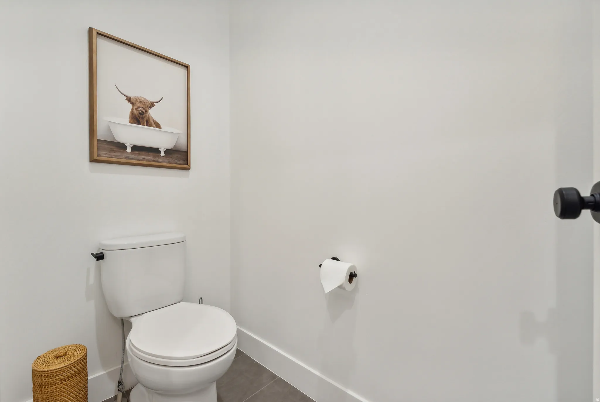 Crisp white walls with contrasting dark fixtures and a modern toilet