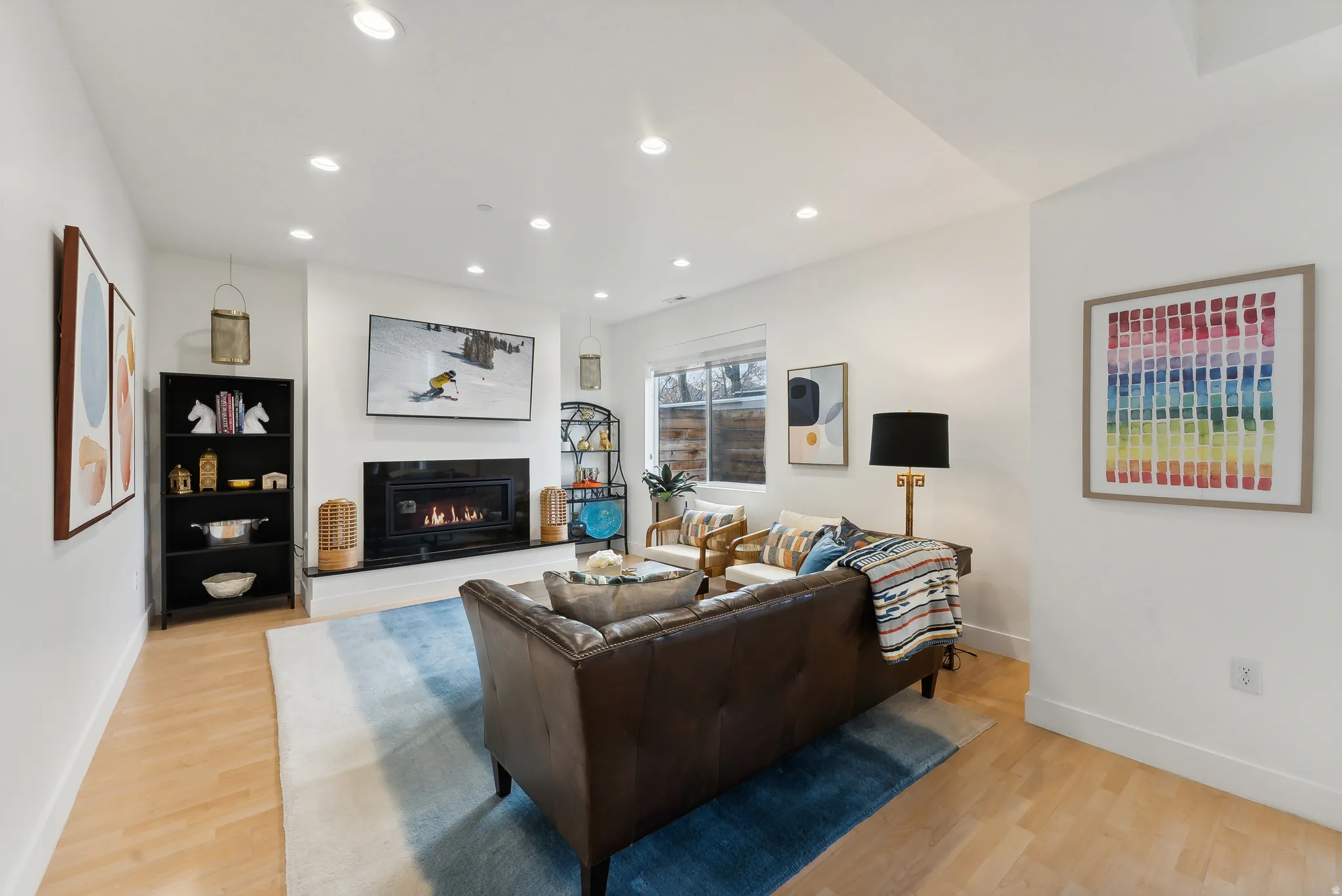 Living area featuring wood-finish flooring and recessed lighting