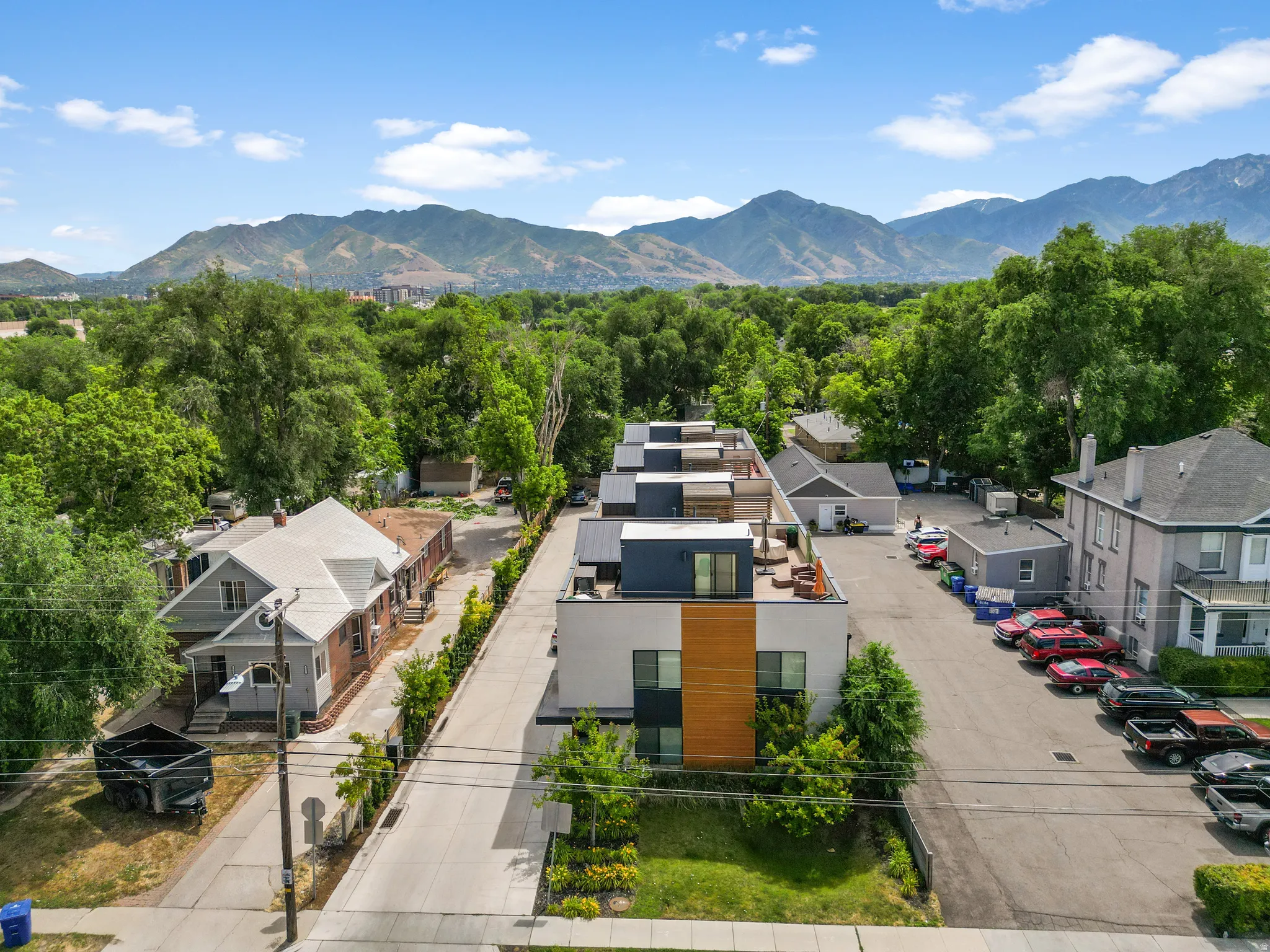 Contemporary multi-unit property featuring a flat roofline and integrated wood-finish paneling