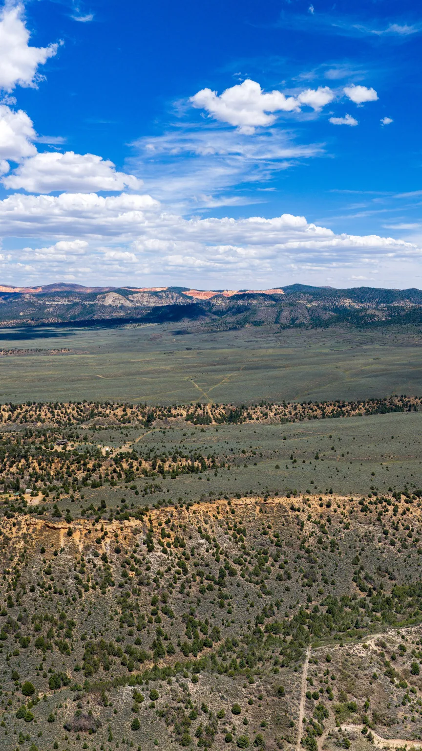 Expansive landscape featuring vast open terrain and distant mountain ranges
