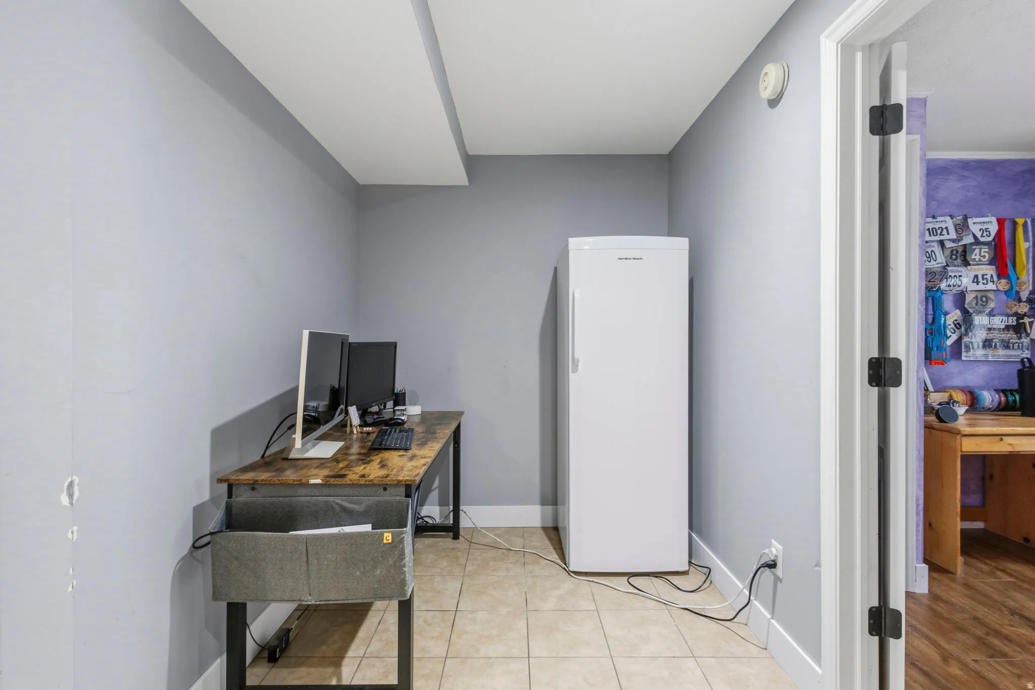 Room with light-toned walls and tile flooring