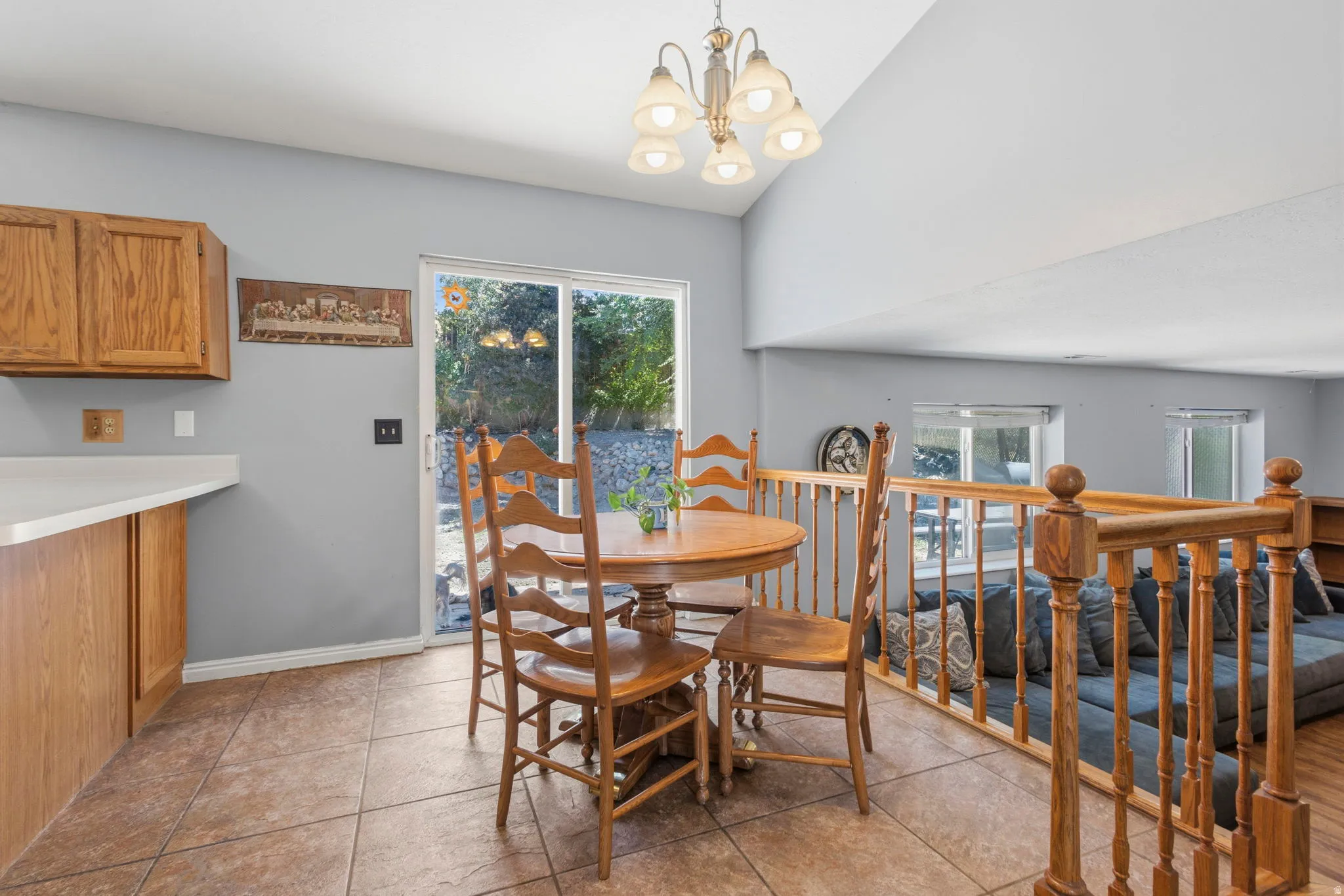 Kitchen area with tile flooring and wood cabinetry