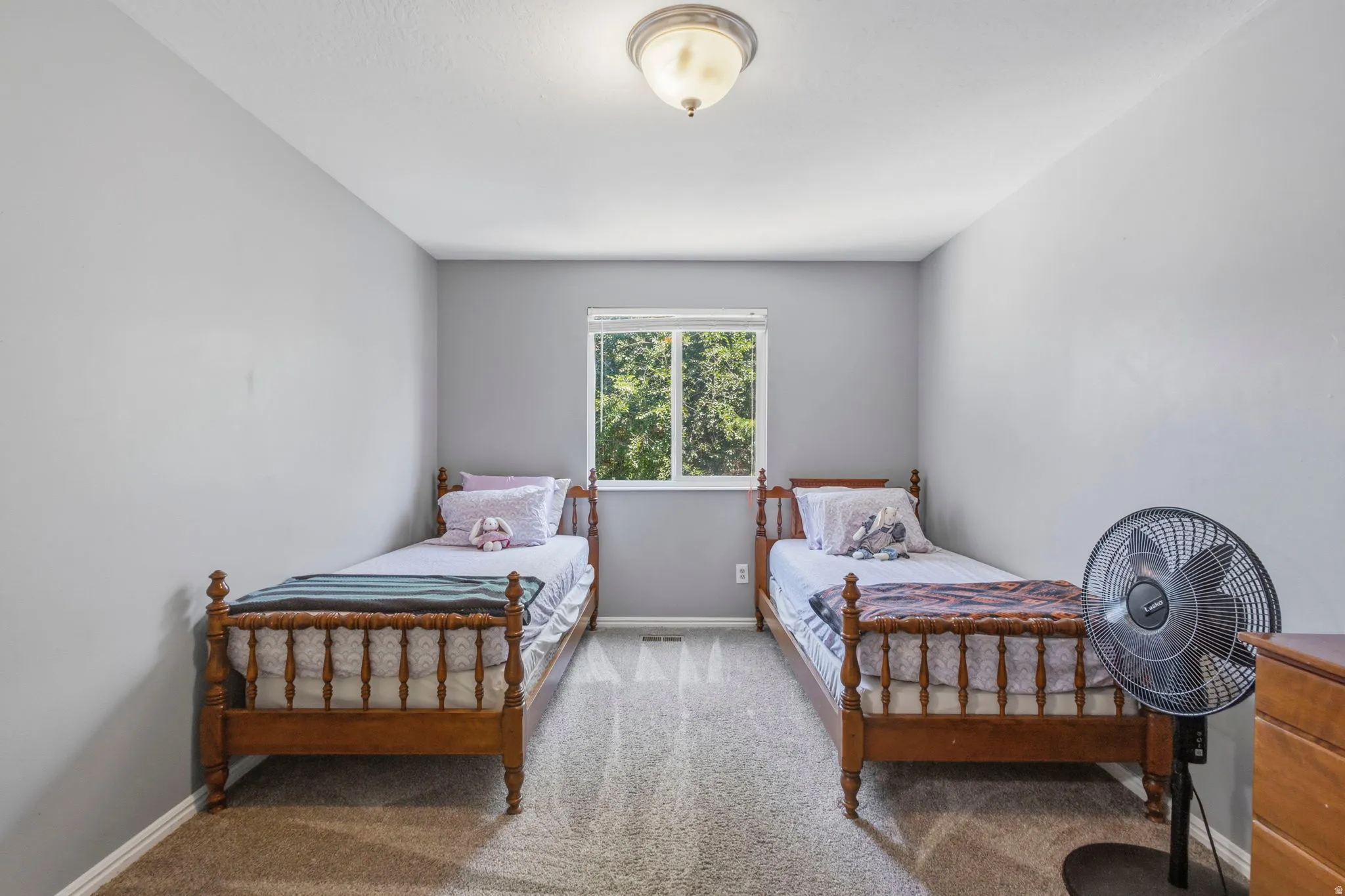 Carpeted room featuring a single window and neutral wall paint