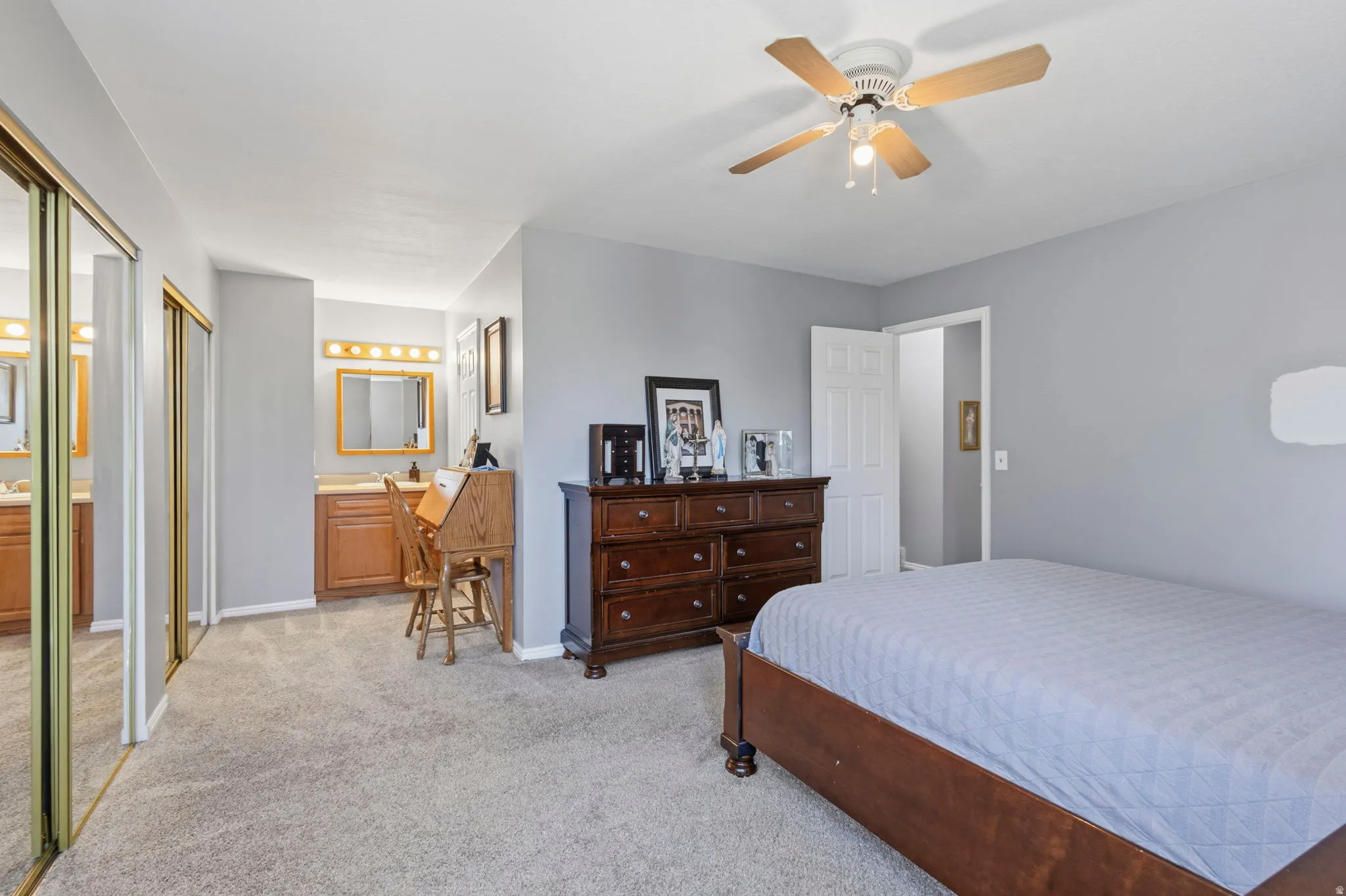 Spacious room featuring light gray walls and plush carpeting