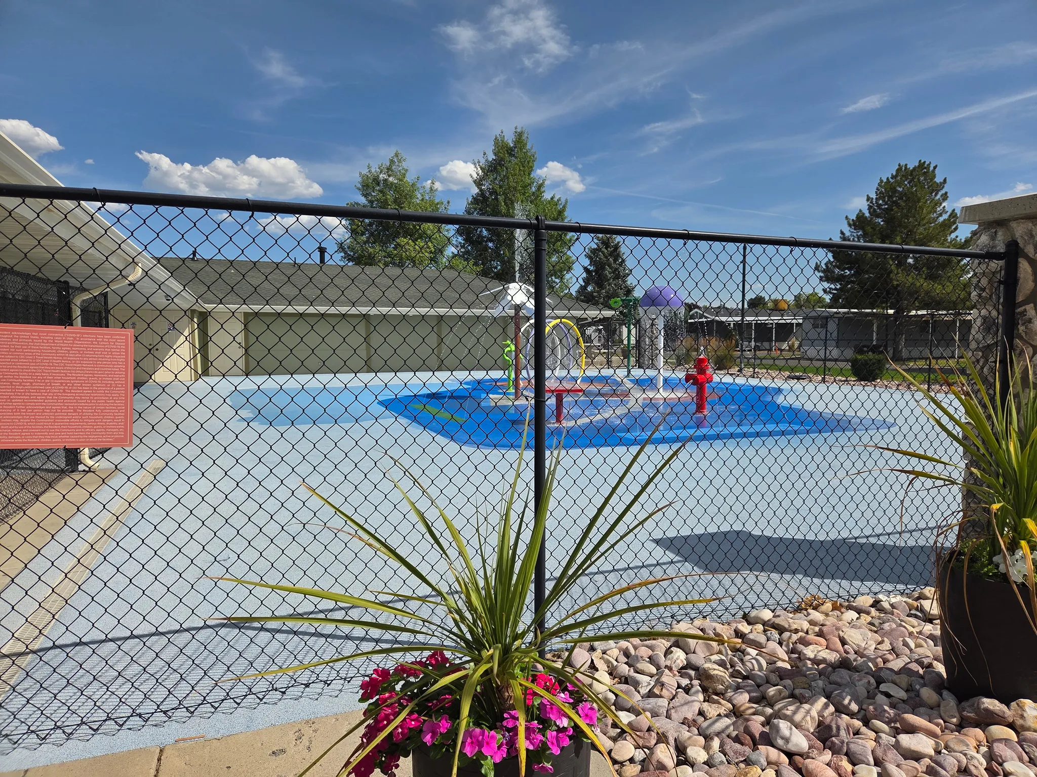 Splash pad area featuring a light blue ground surface with a darker blue central design