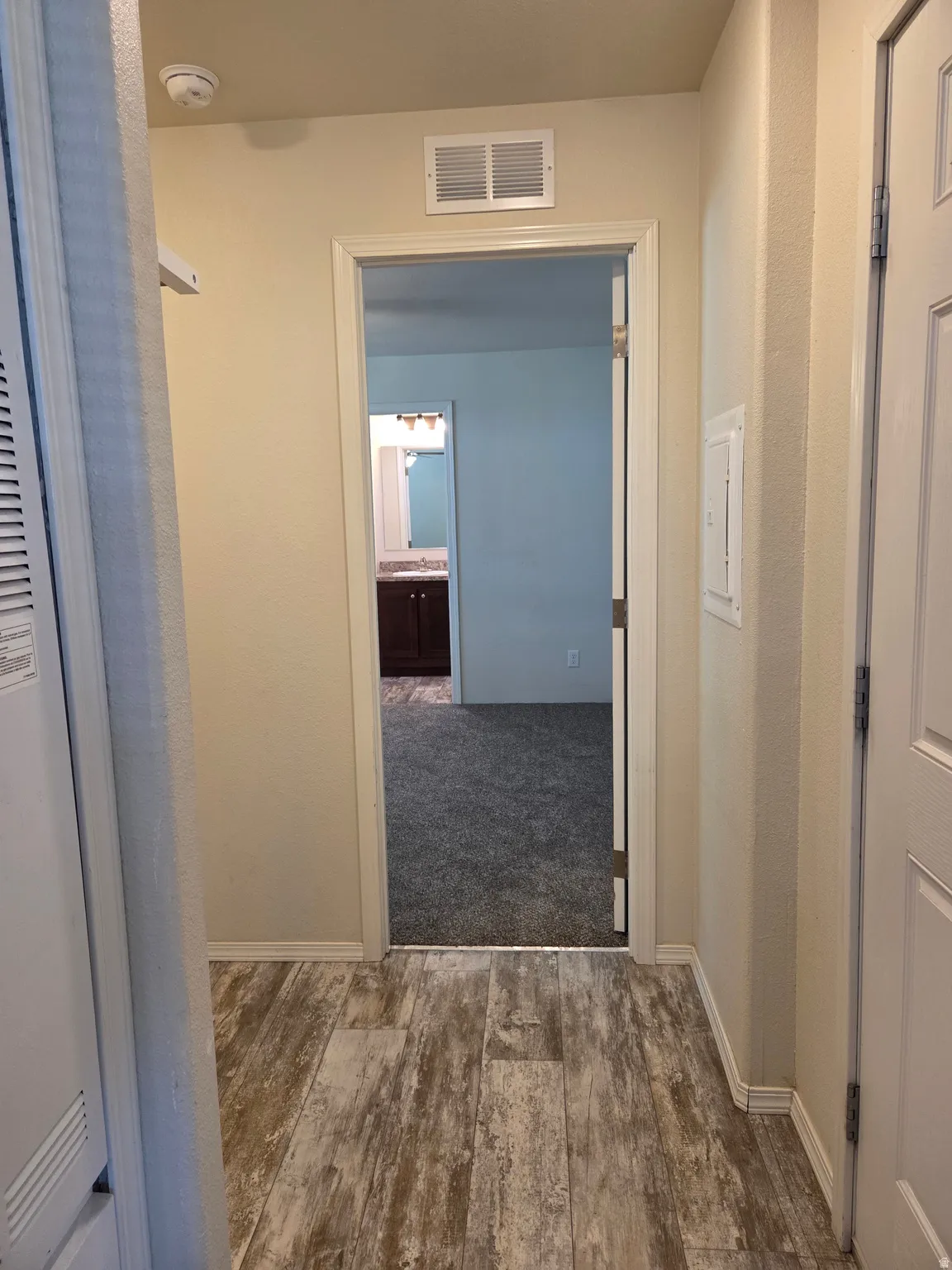 Laundry room off of the hallway, between the kitchen and the master bedroom.