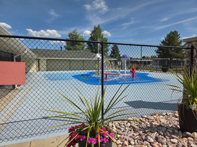 Splash pad area featuring a light blue ground surface with a darker blue central design