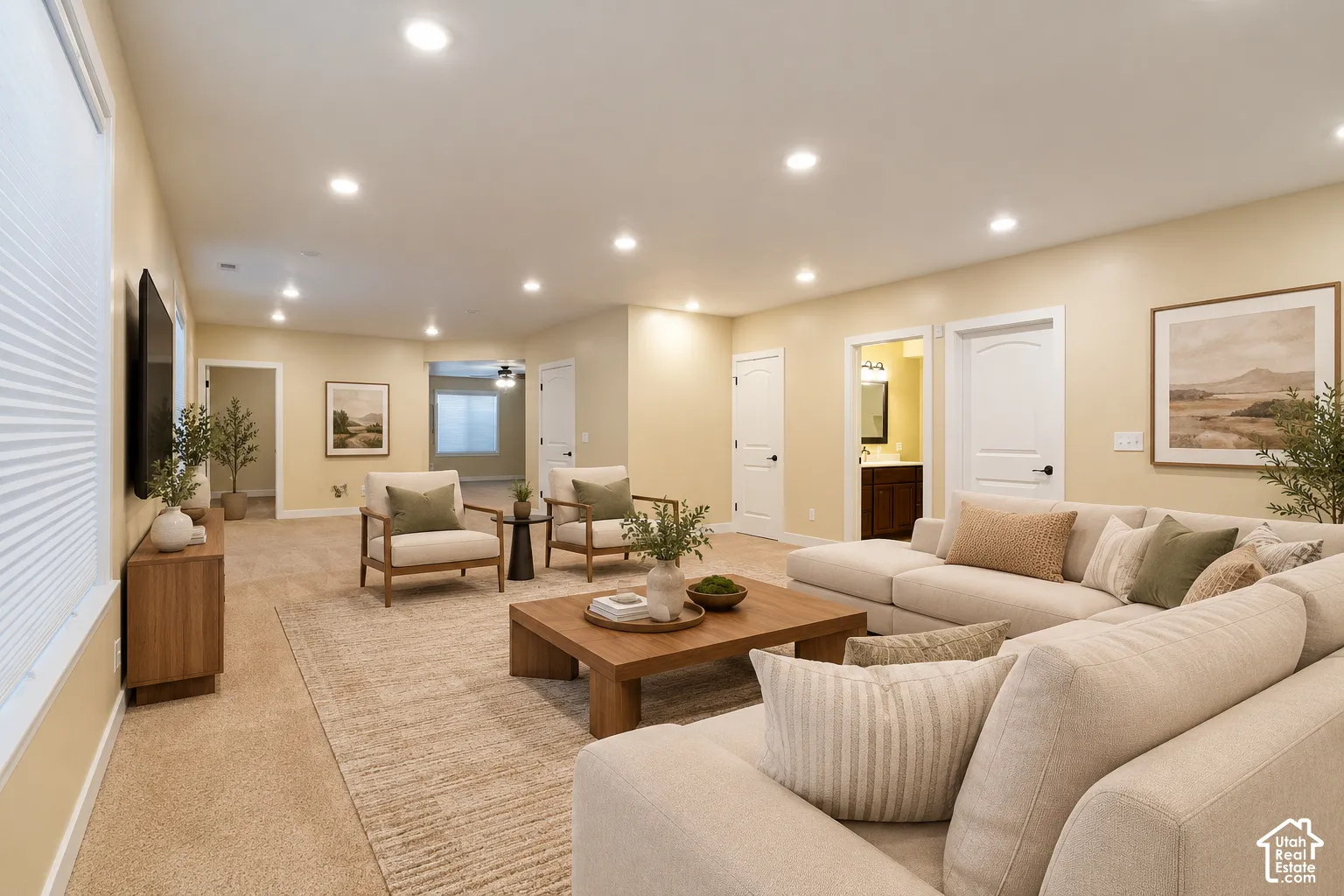 Spacious interior featuring recessed lighting, multi-panel doors, neutral wall tones, and carpeted flooring
