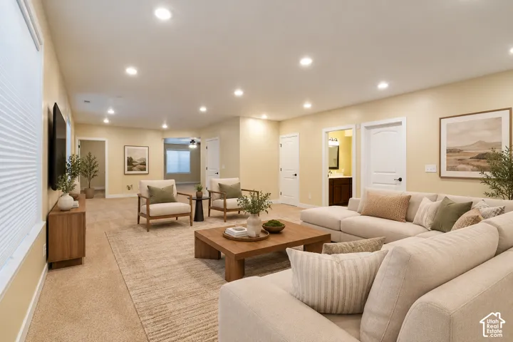Spacious interior featuring recessed lighting, multi-panel doors, neutral wall tones, and carpeted flooring