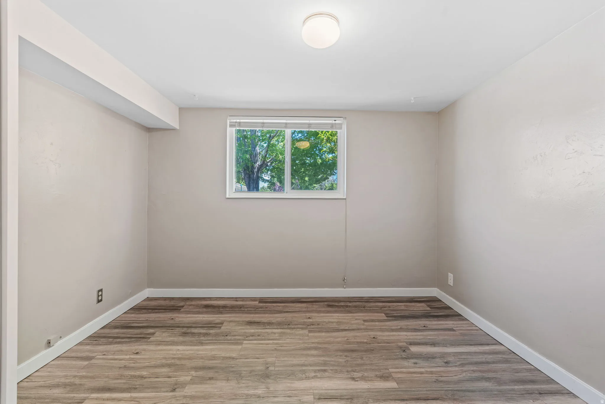 Bedroom featuring wood-finish flooring