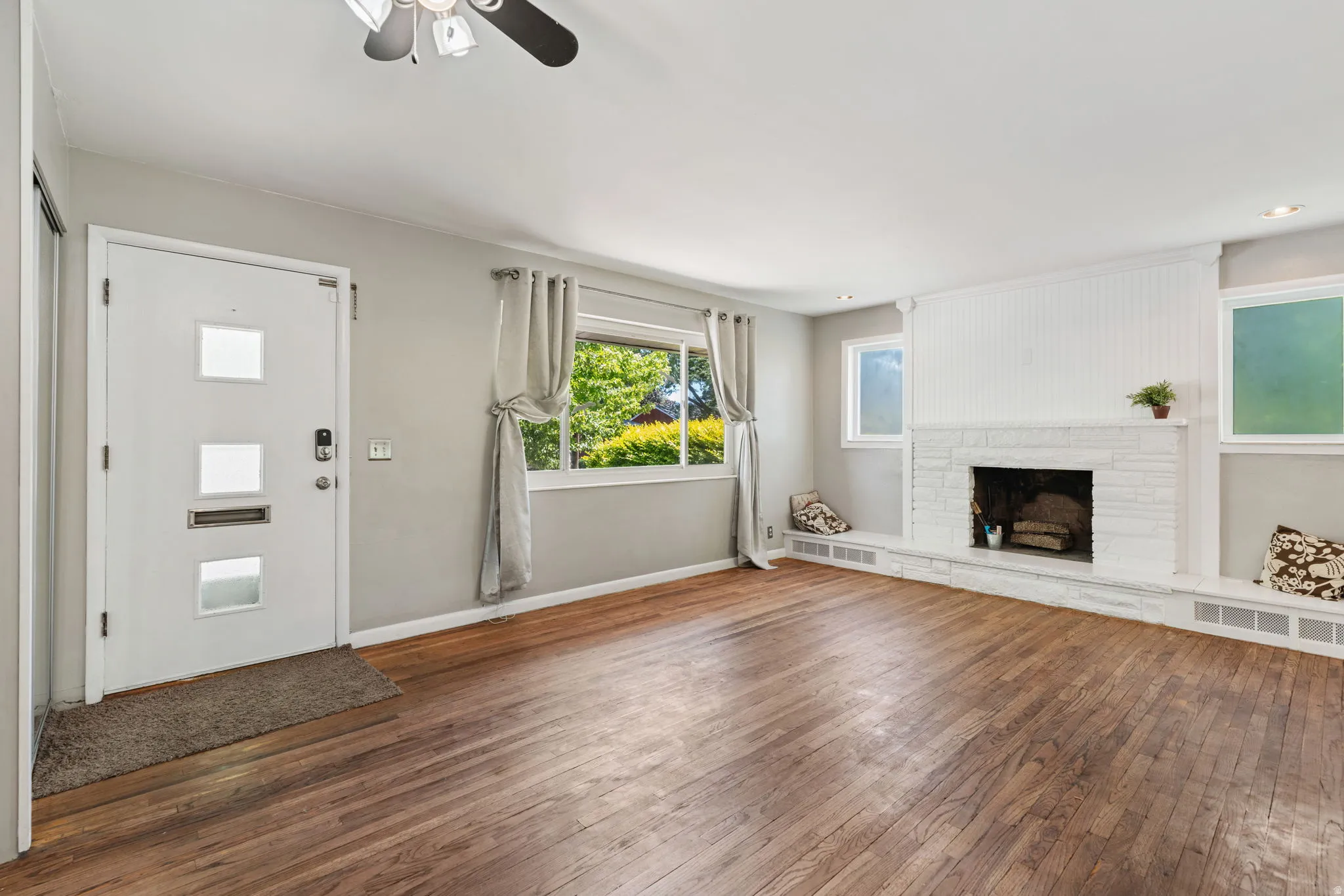 Living area featuring rich wood-finish flooring and light gray wall paint