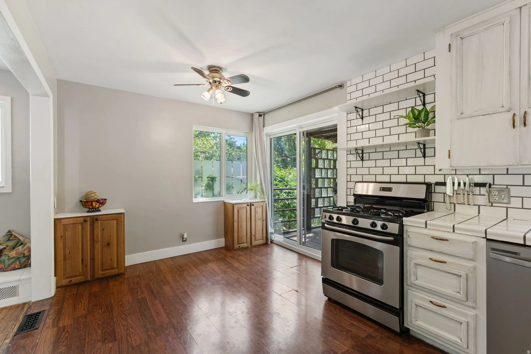 Kitchen area featuring rich wood-finish flooring and a stainless steel gas range