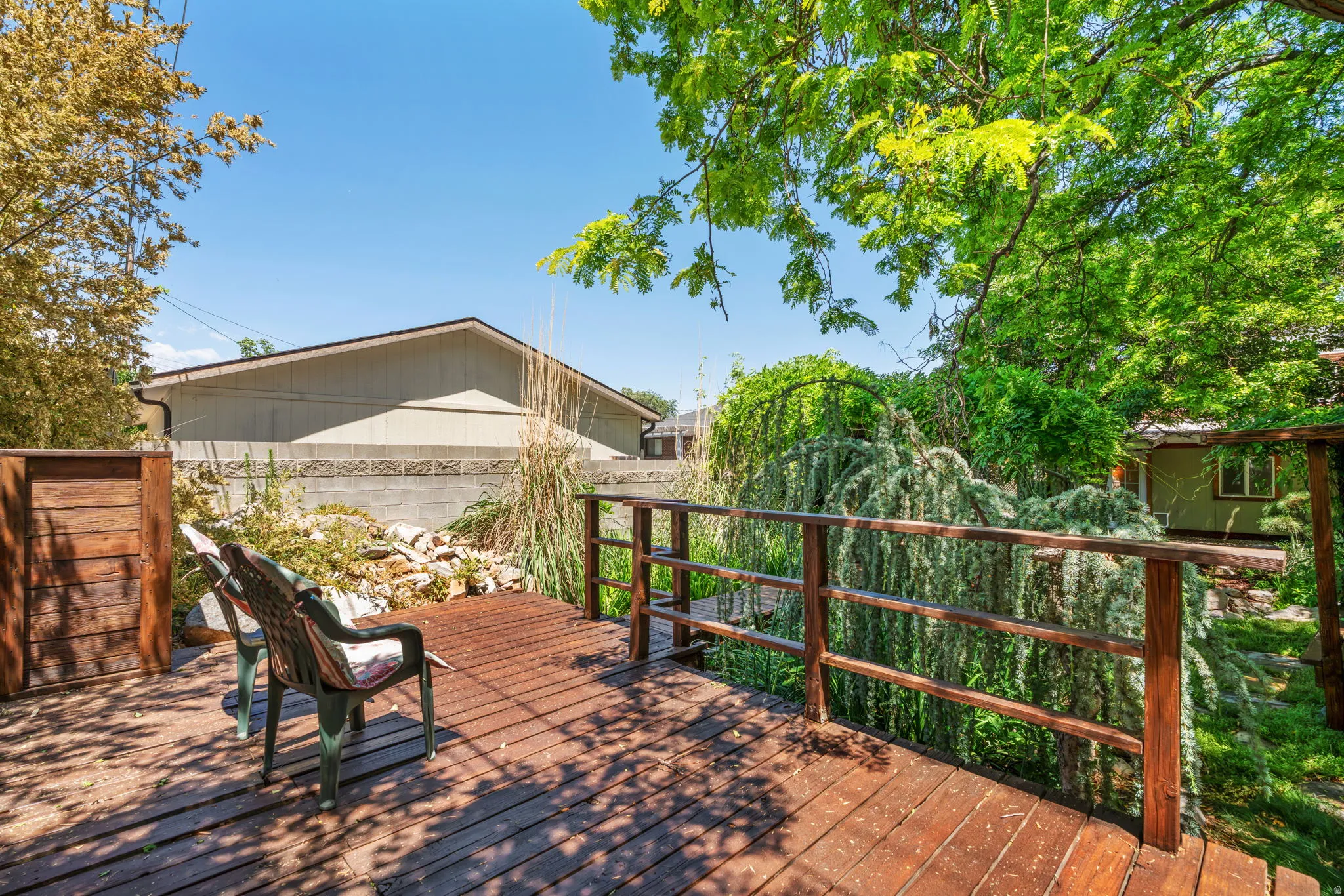 Wood-finish deck in backyard outside workshop