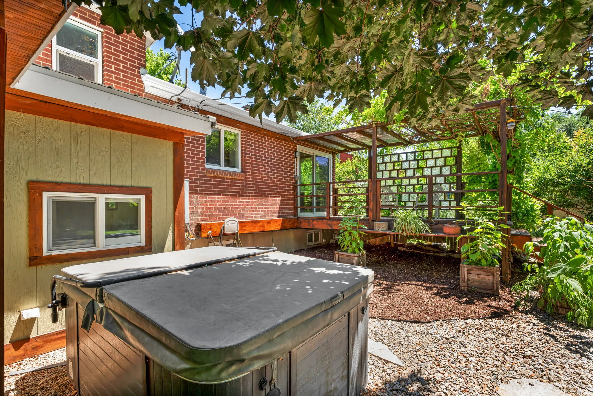 Outdoor hot tub with protective cover