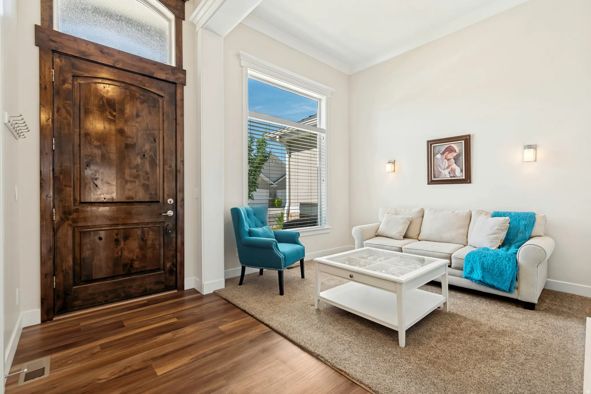 Grand entry featuring a dark wood door with an arched top panel and an overhead frosted transom window