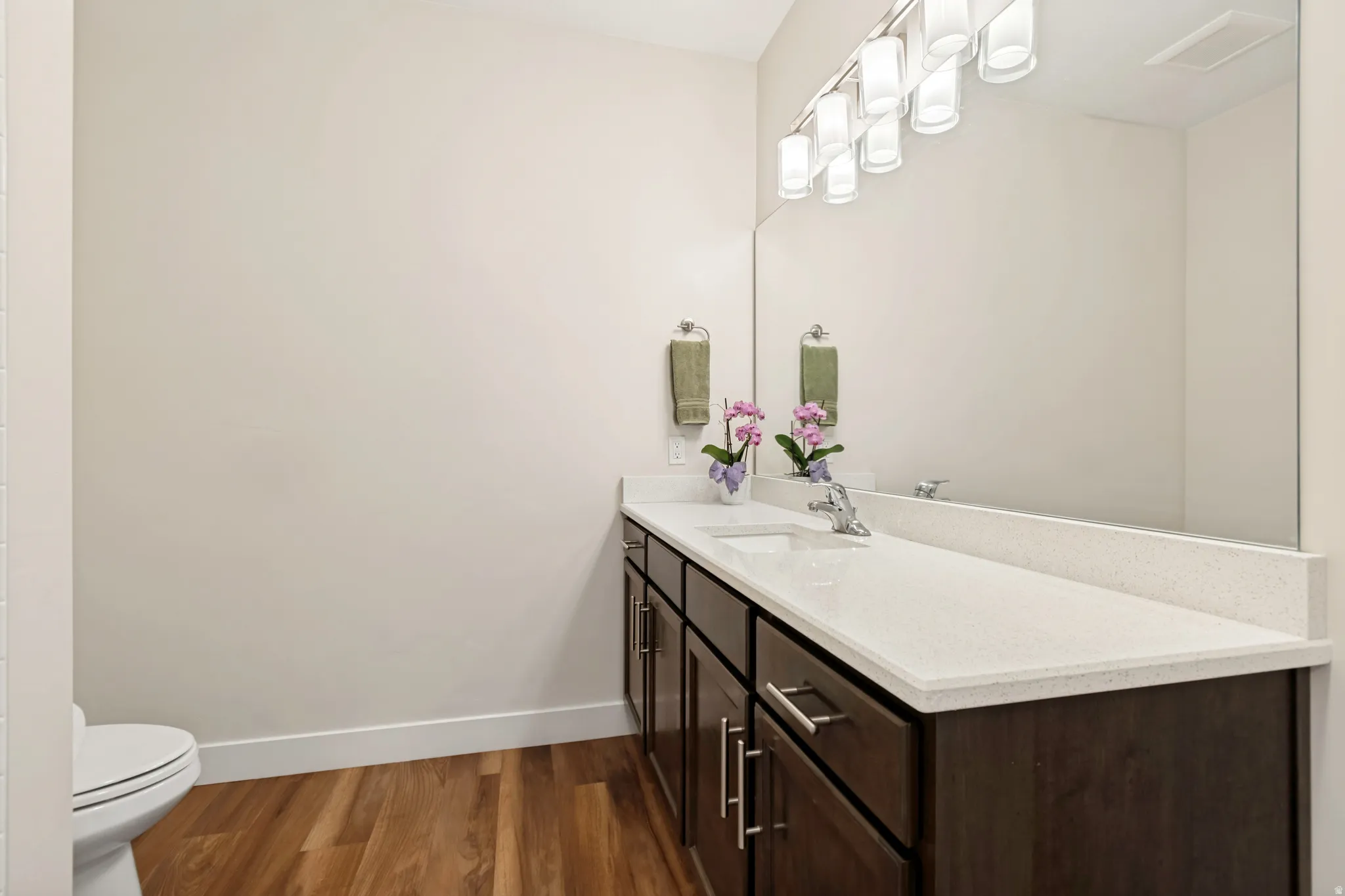 Double vanity with a light-toned countertop, dual sinks, and under-mount cabinetry