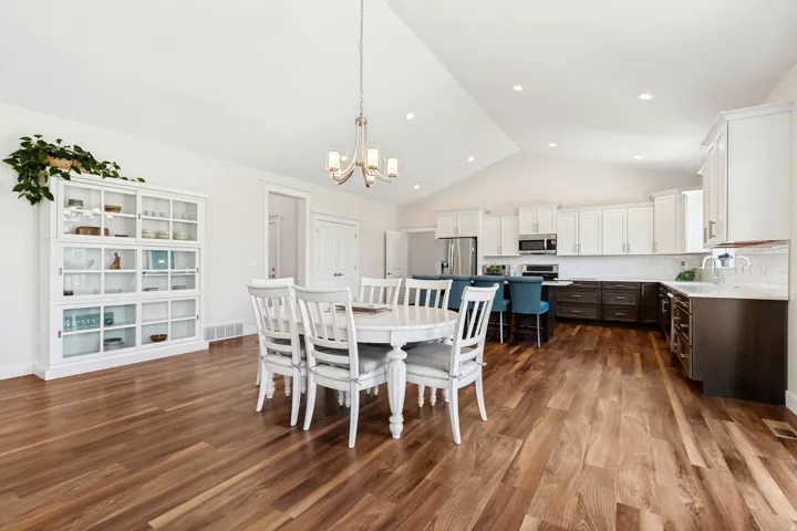 Open-concept kitchen and dining area with vaulted ceilings