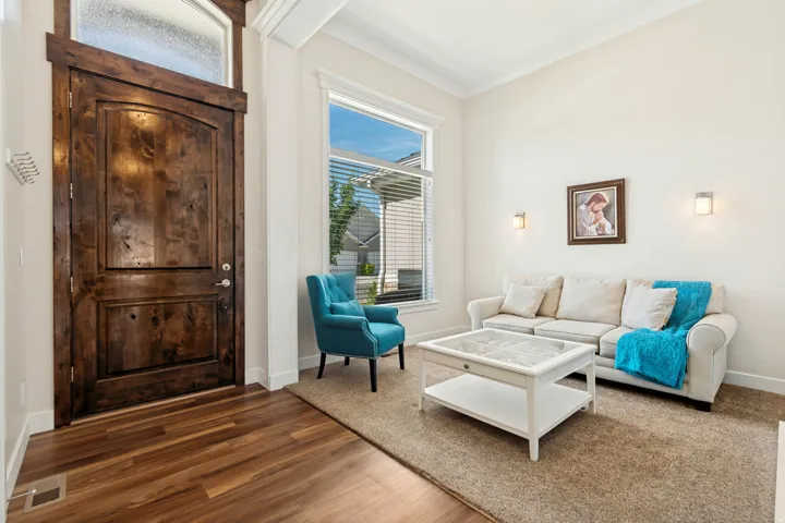 Grand entry featuring a dark wood door with an arched top panel and an overhead frosted transom window