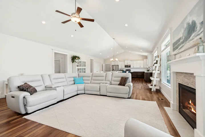 Vaulted ceilings with recessed lighting and a ceiling fan