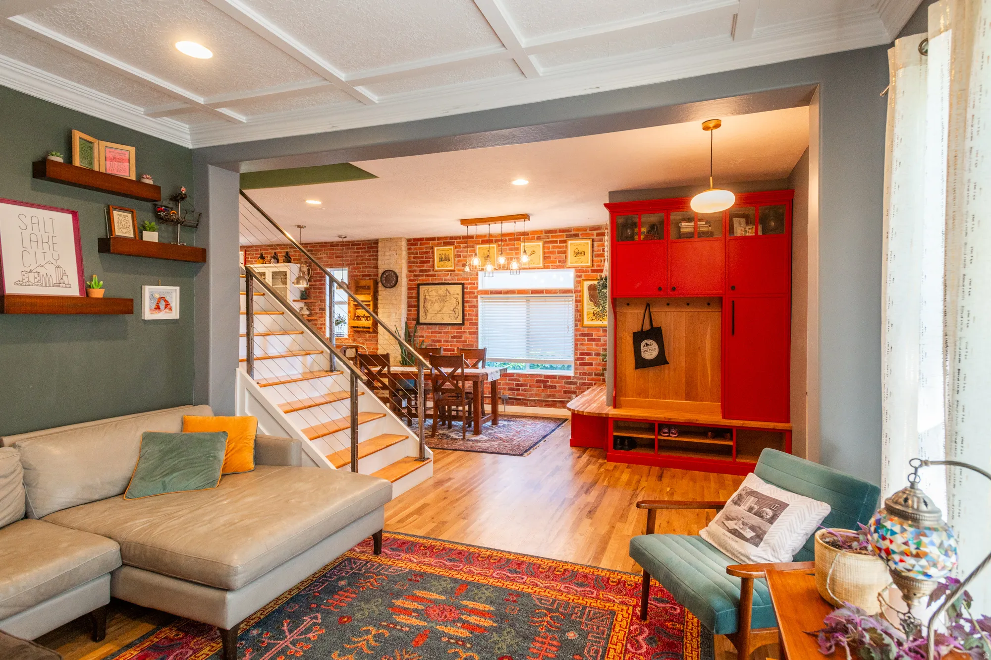 Open-concept living area featuring a coffered ceiling, recessed lighting, and wood-finish flooring