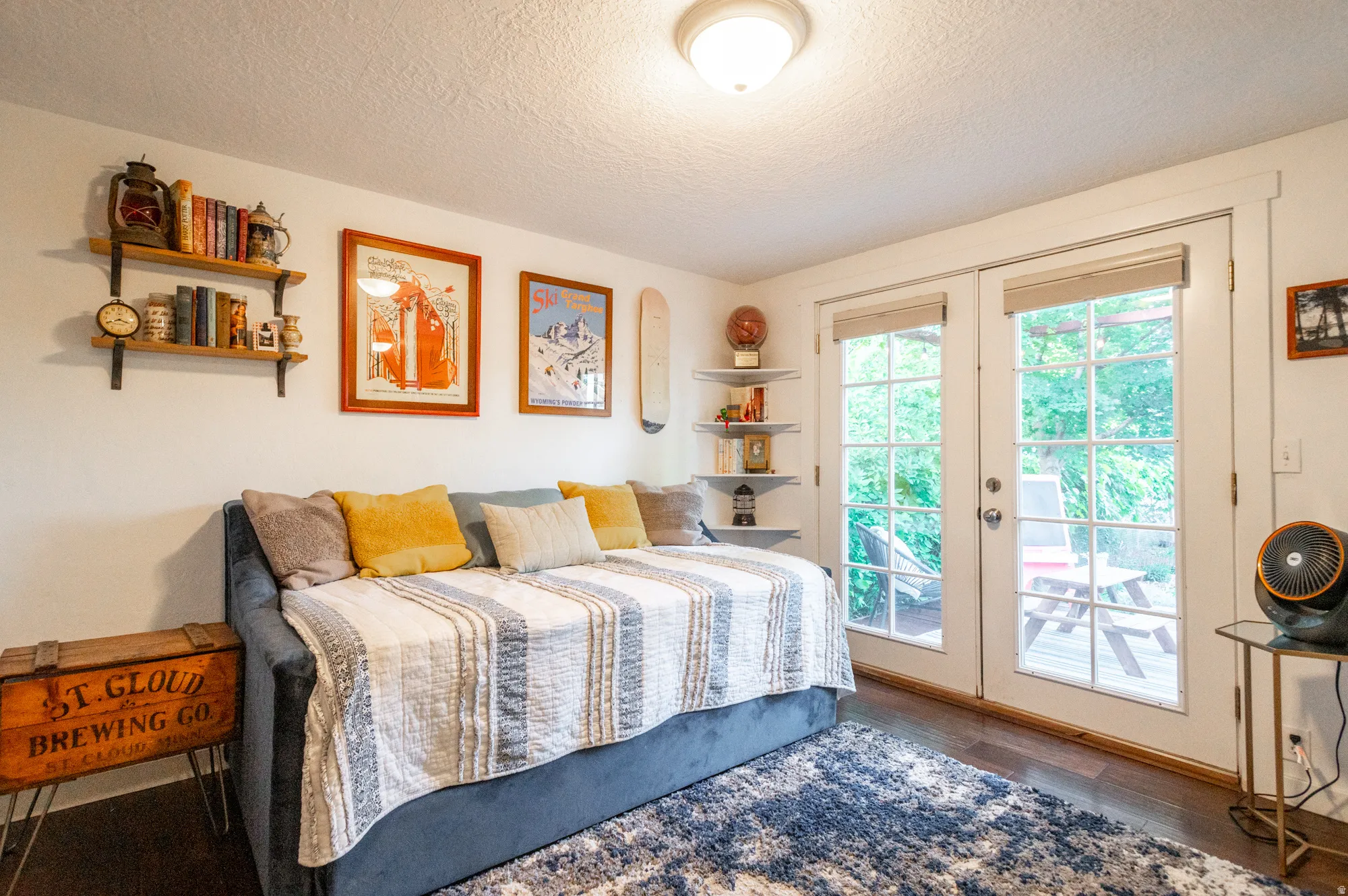 French doors with multiple panes open to an outdoor deck