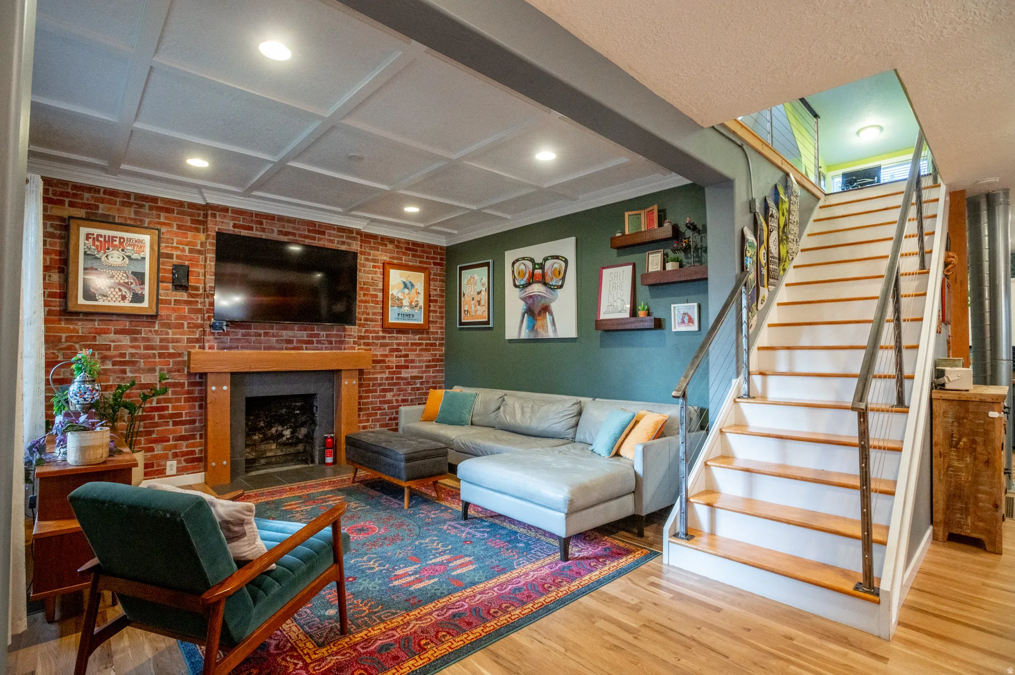 Exposed brick wall featuring a fireplace with a wood mantle and dark surround