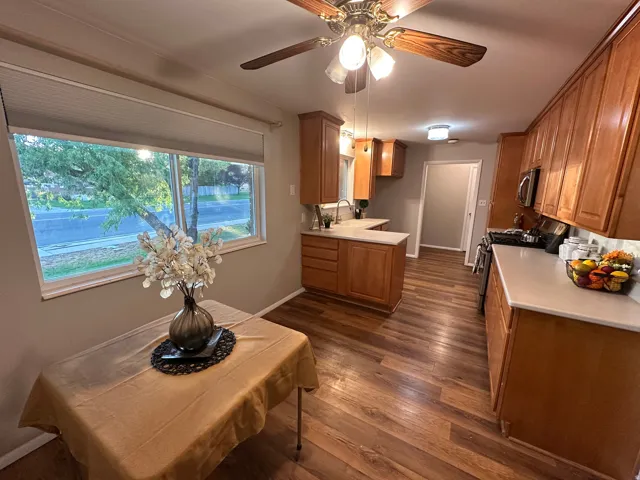Dining with large window and a ceiling fan