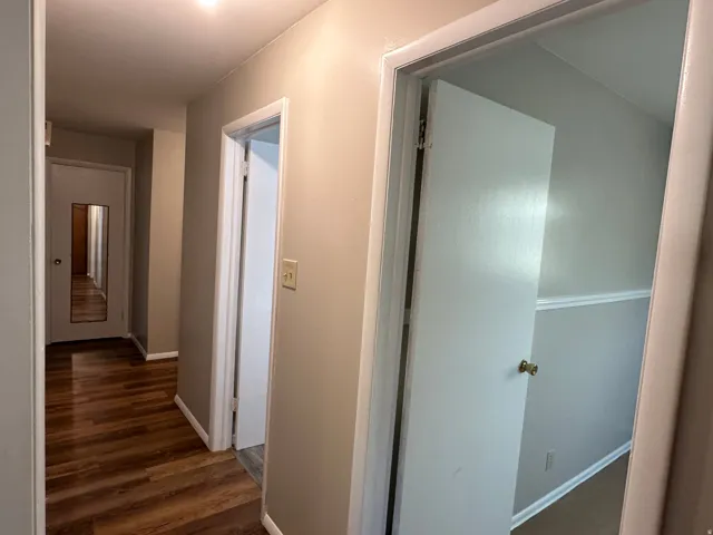 Hallway including coat closet with mirror