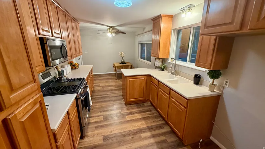 Kitchen view 2 - Lots of counter space, large pantry, semi formal dining  with ceiling fan and large window.