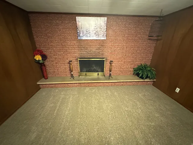 Brick fireplace with a brass firebox