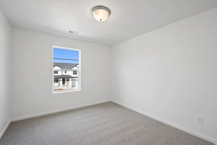 Neutral-toned carpeting throughout the room