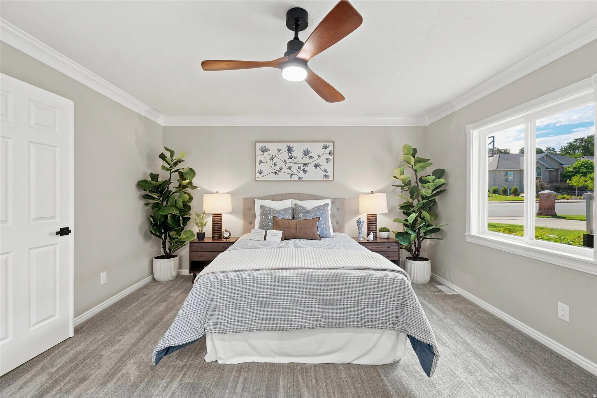 Bedroom featuring wood-finish flooring, a contemporary ceiling fan, and crown molding