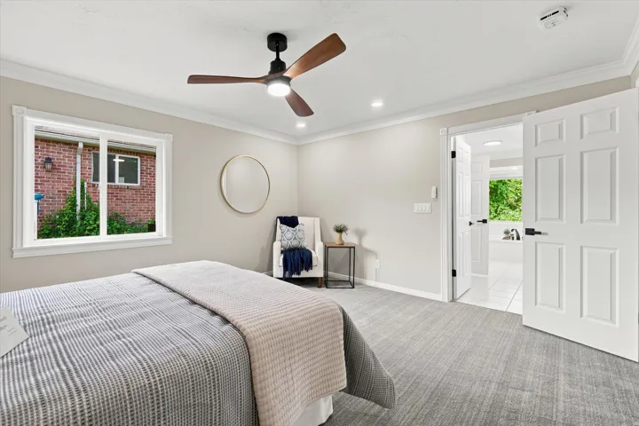 Bedroom featuring a contemporary ceiling fan with integrated lighting, recessed lighting, and a window with white trim