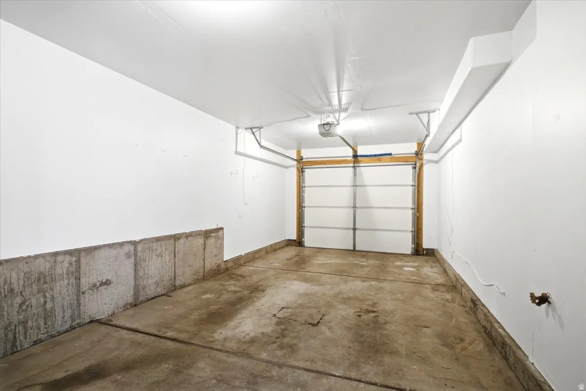 Attached garage with a sectional overhead door and an automatic opener