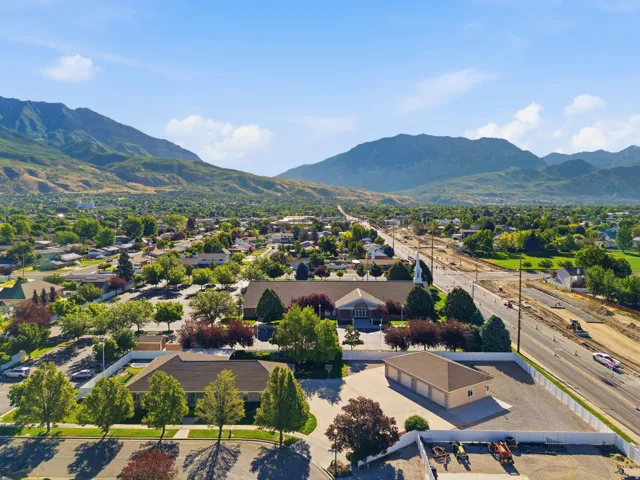 Aerial perspective showcasing a community with mature trees and mountain ranges