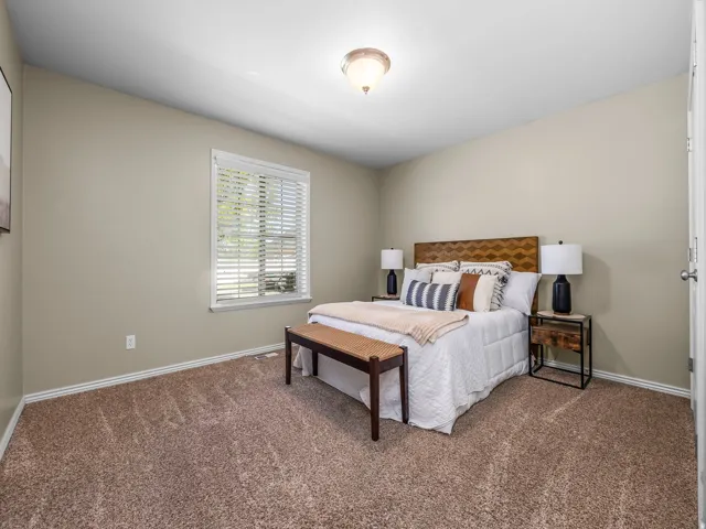 Neutral-toned walls complement plush carpeting