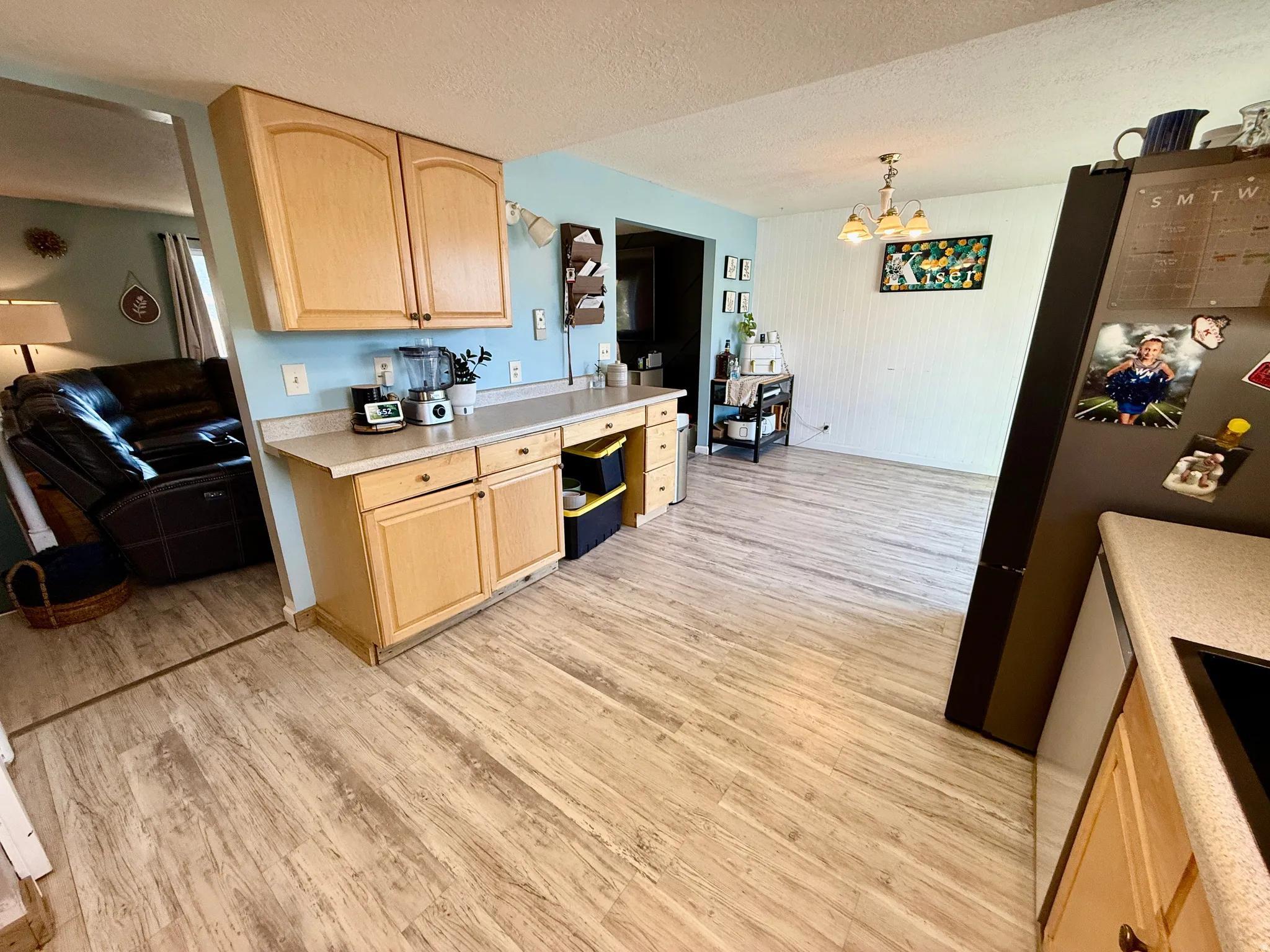 Light wood-finish flooring extending throughout the space