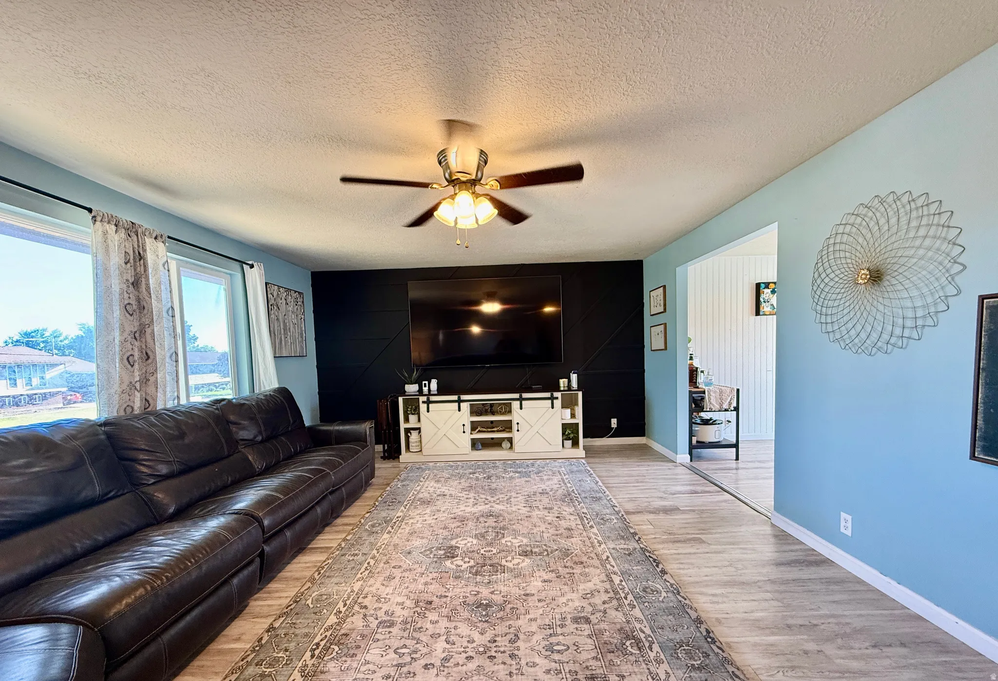 Living space featuring light wood-finish flooring and light blue walls
