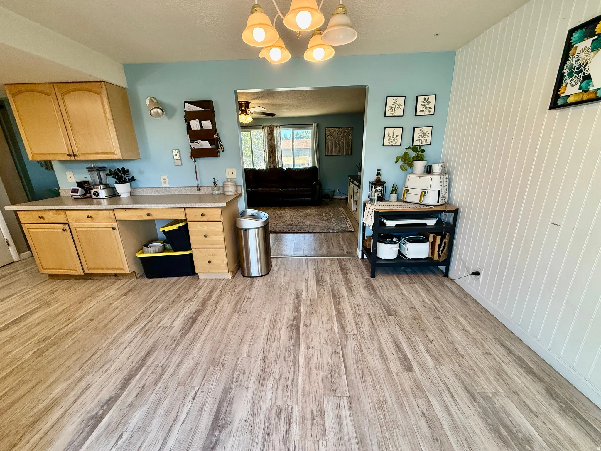 Kitchen area featuring wood-finish flooring, light wood cabinetry, and a light-toned countertop