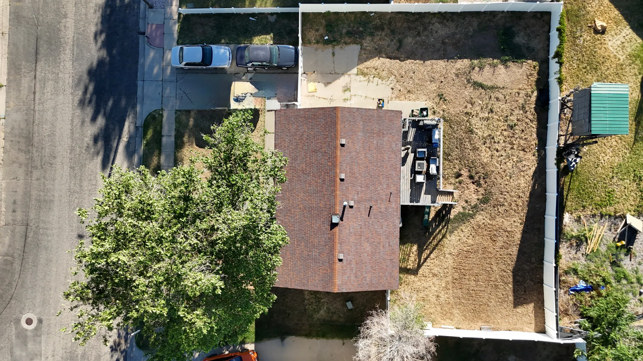 Expansive property featuring a brown shingle roof and a concrete driveway