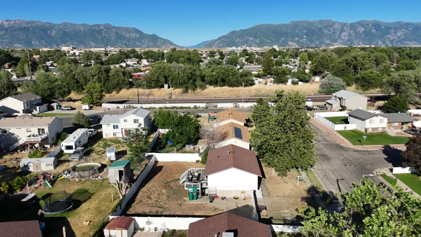 Residential neighborhood featuring mountain backdrops and a railroad corridor