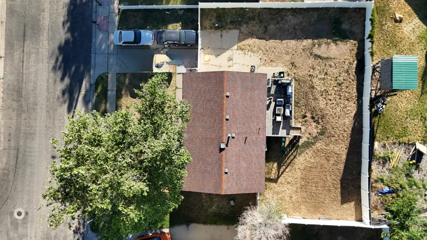 Expansive property featuring a brown shingle roof and a concrete driveway