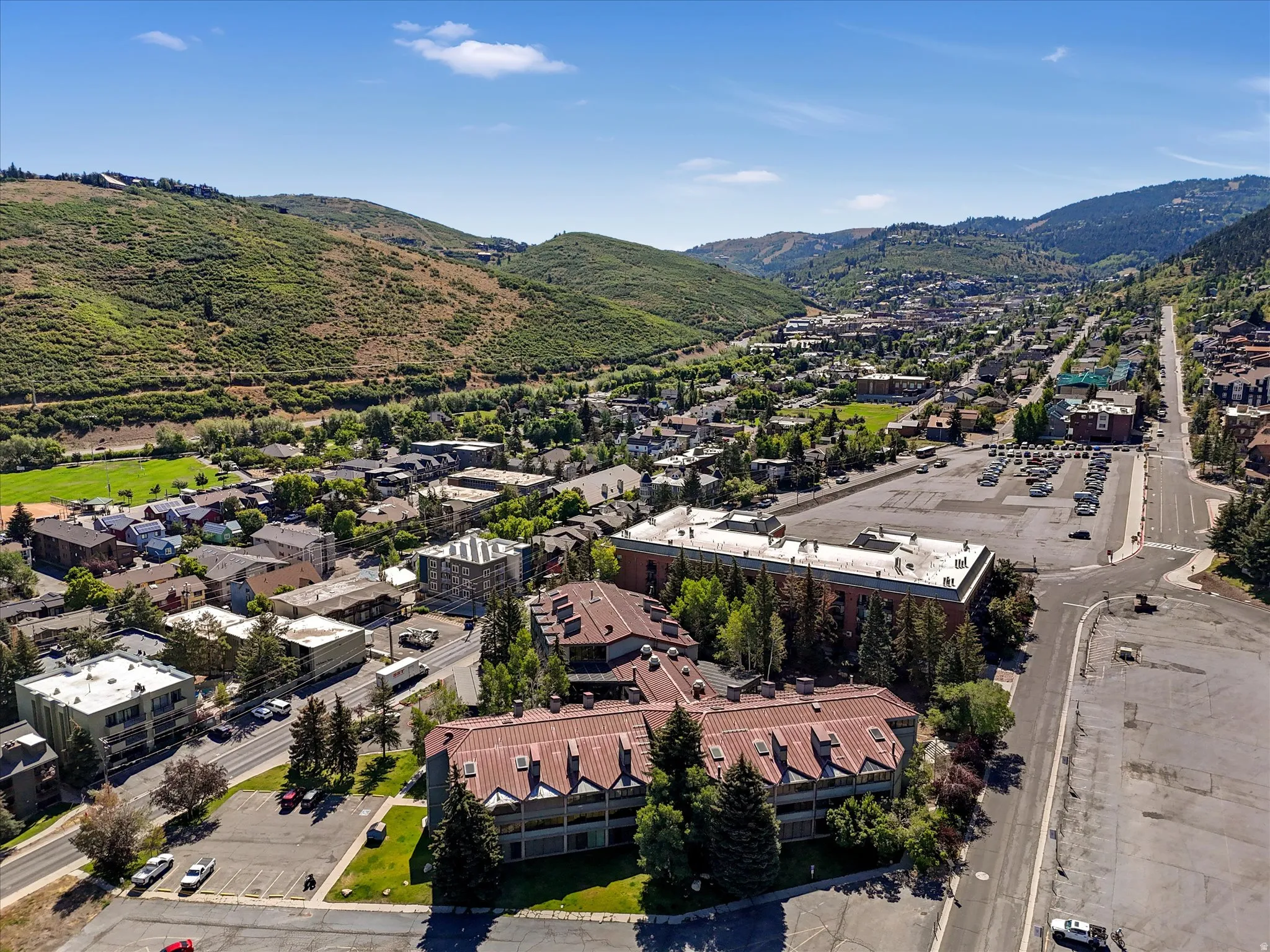 Aerial perspective showcasing a vibrant community nestled within a mountainous landscape