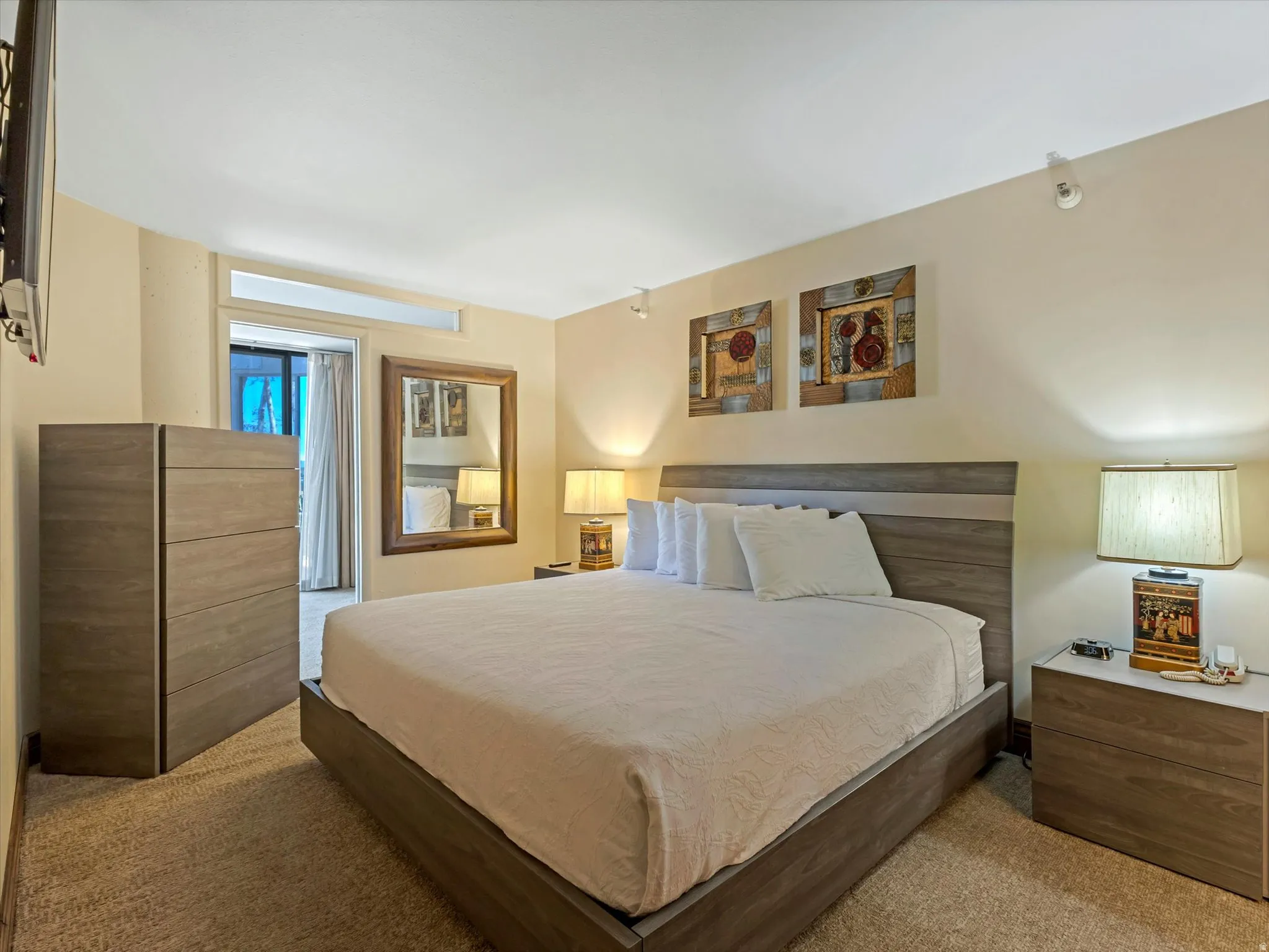 Bedroom with wood-finish flooring, recessed lighting, and a transom window above the doorway