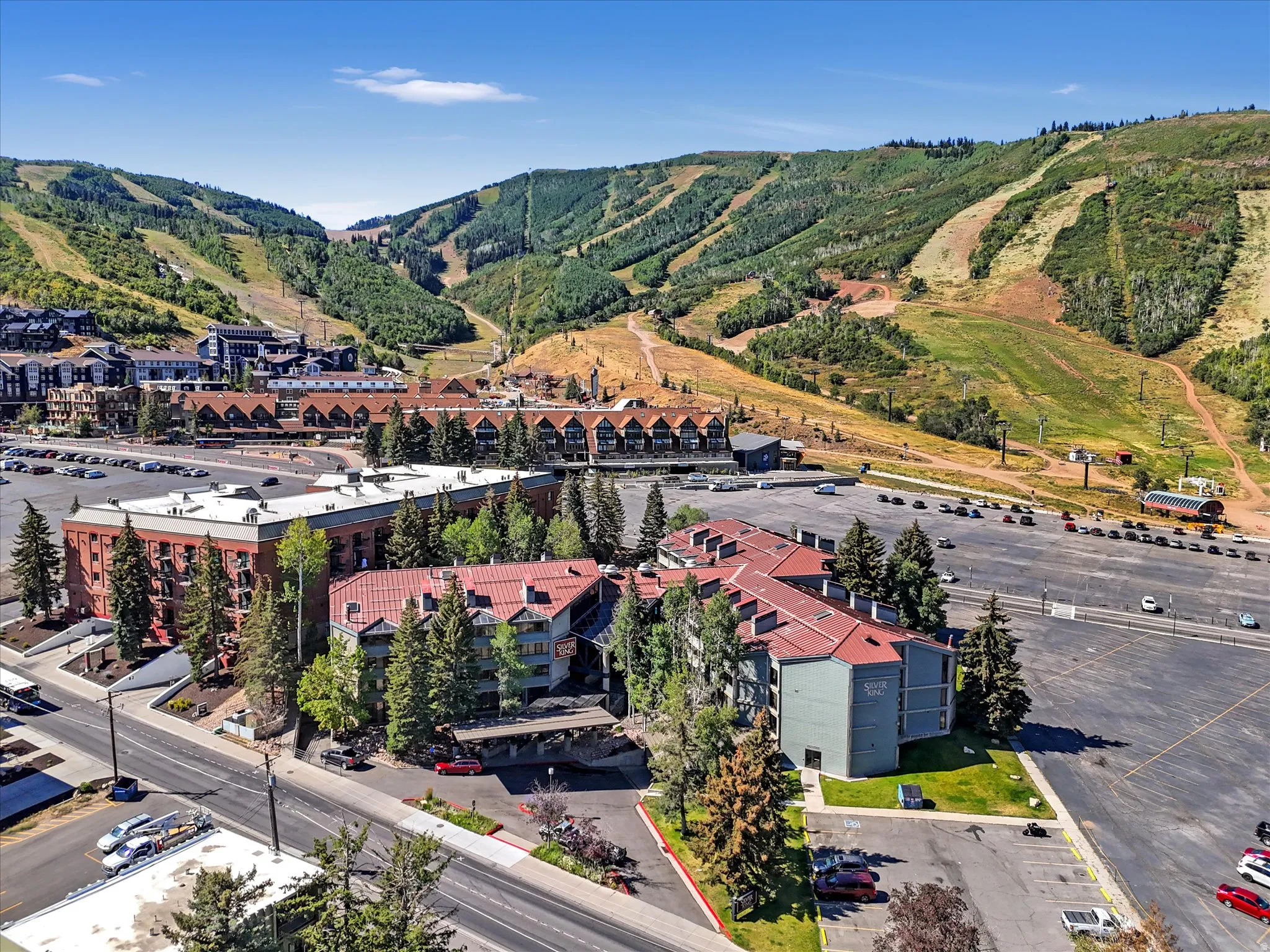 Aerial perspective showcasing a multi-building property with surrounding mountainous terrain