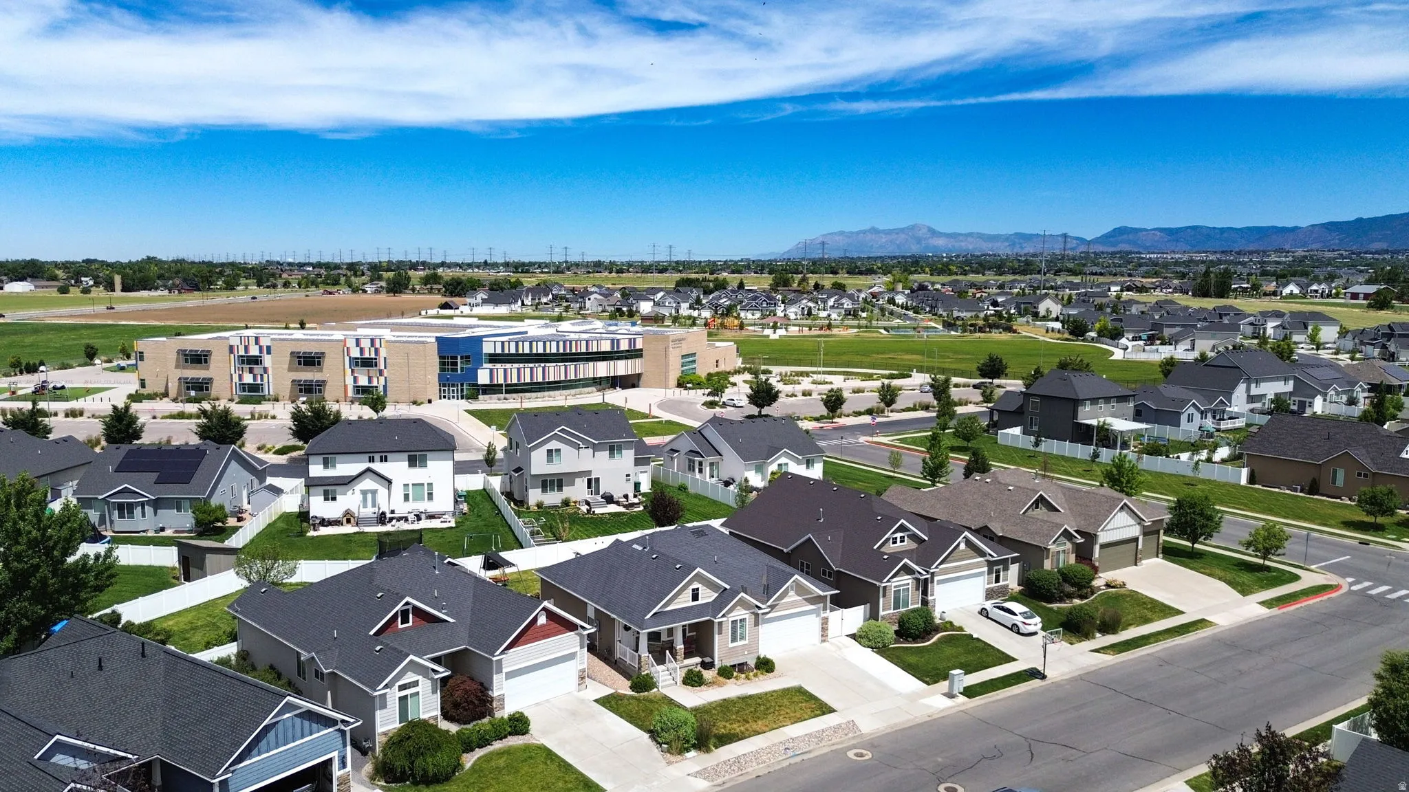 Residential neighborhood featuring a variety of single-family homes with pitched roofs and manicured lawns