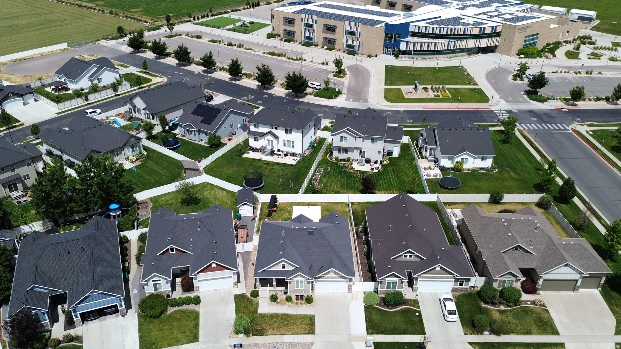 Aerial perspective showcasing residential properties with a contemporary educational facility