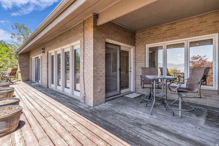 Expansive wood-finish deck with a durable brick exterior