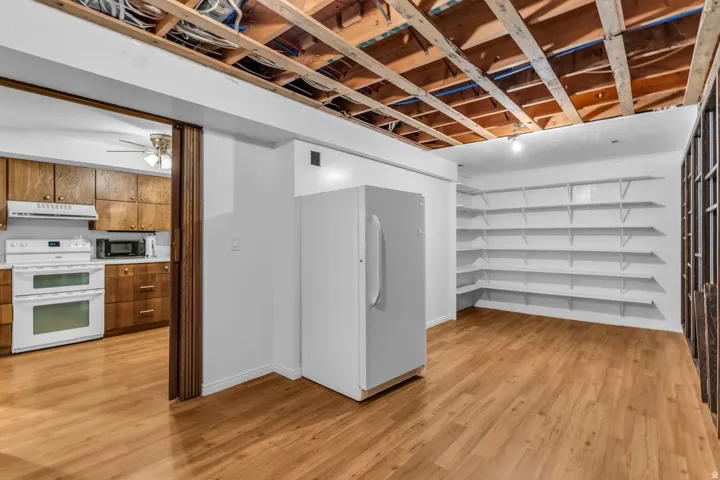 Versatile room featuring wood-finish flooring and extensive built-in shelving